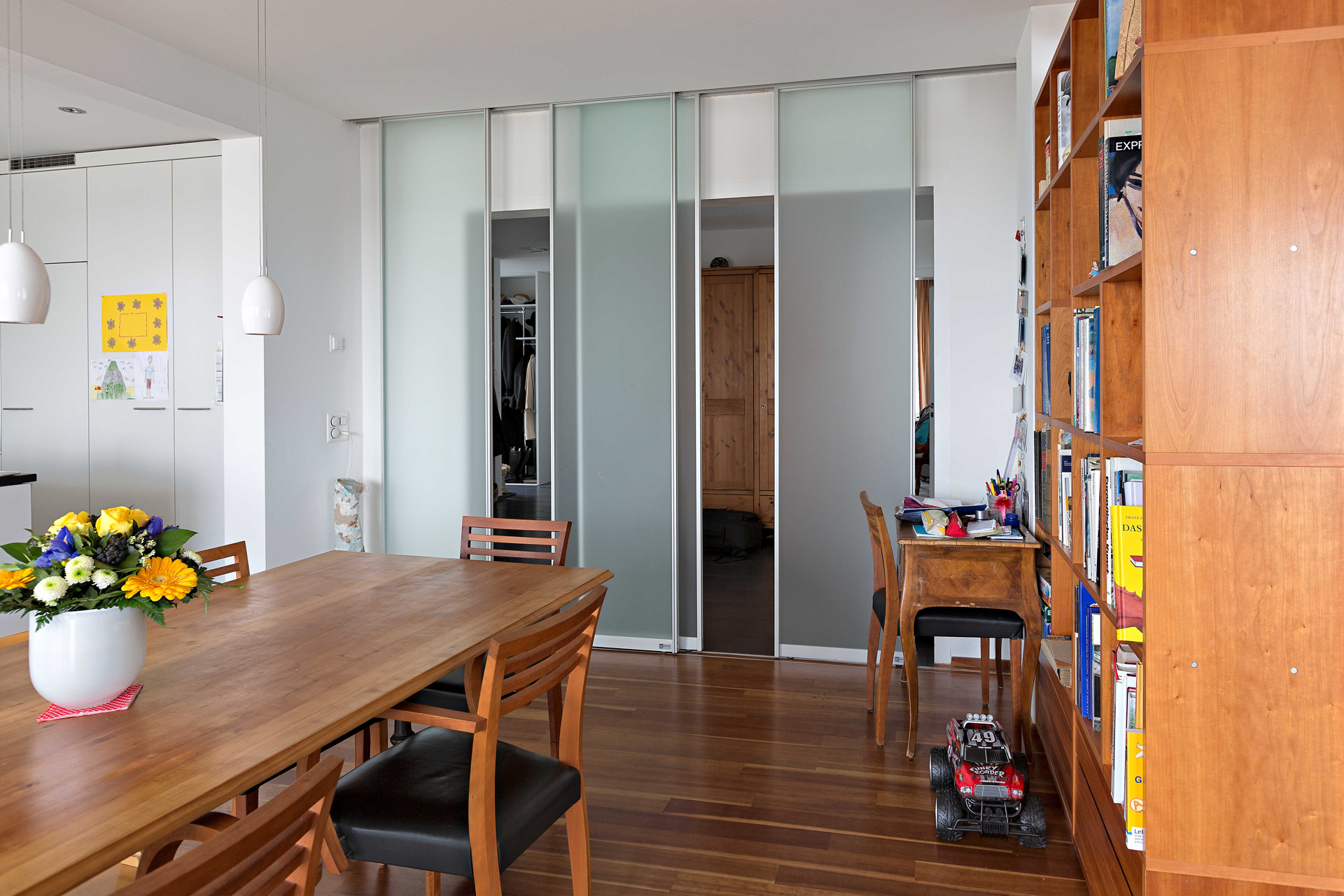 Raumteiler aus vier Schiebetüren in Glas zwischen Flur und Wohnbereich