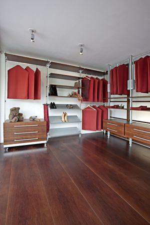 Begehbare Ankleide im Innensystem Alu mit Tablaren in Nuss und fahrbarem Ladenkorpus im Schauraum AUF&ZU